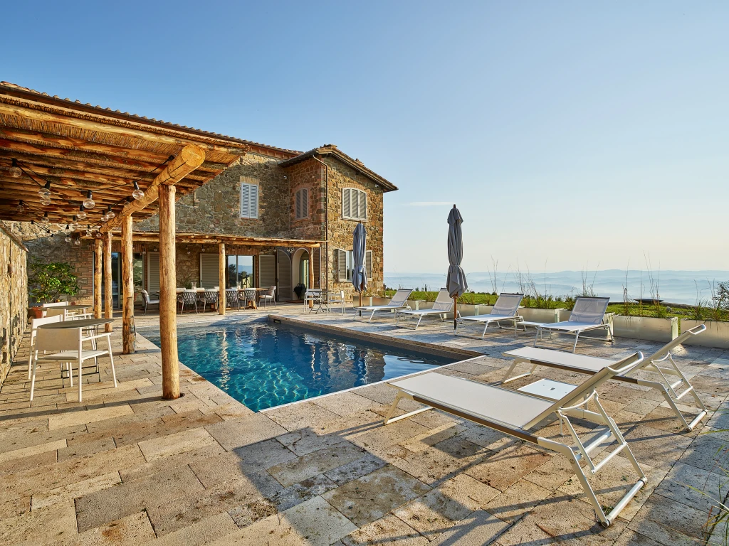 The swimming pool at Villa Palazzetta, surrounded by vineyards and breathtaking views
