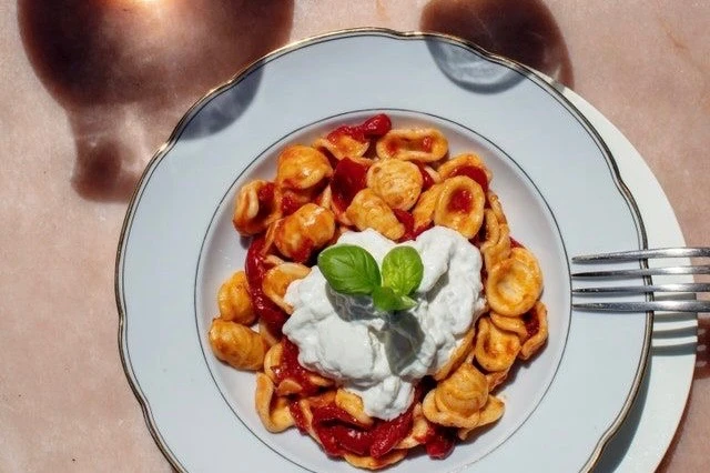 Orecchiette with roasted tomatoes and stracciatella cheese.