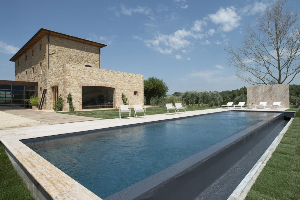 The highlight is a stunning panoramic infinity pool (16mx4m) with sun beds and deck chairs, providing breathtaking views of the rolling hills.