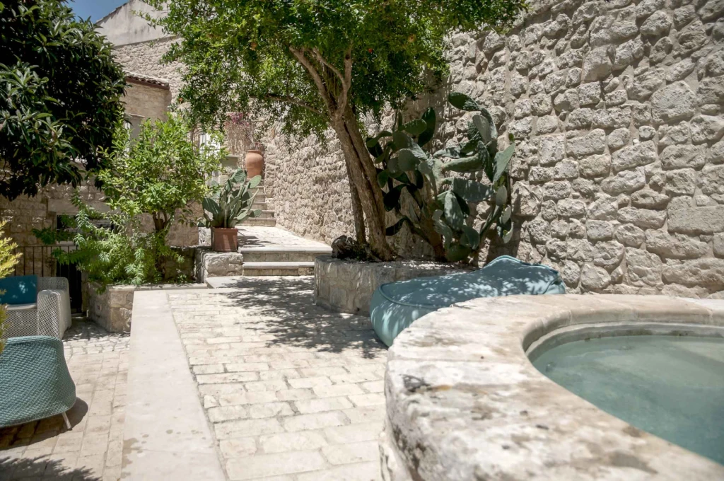 Sheltered by tall walls, you can relax in the stone hot tub, enjoy a massage under the pomegranate tree, have dinner, or read in the shadows of the citrus trees.