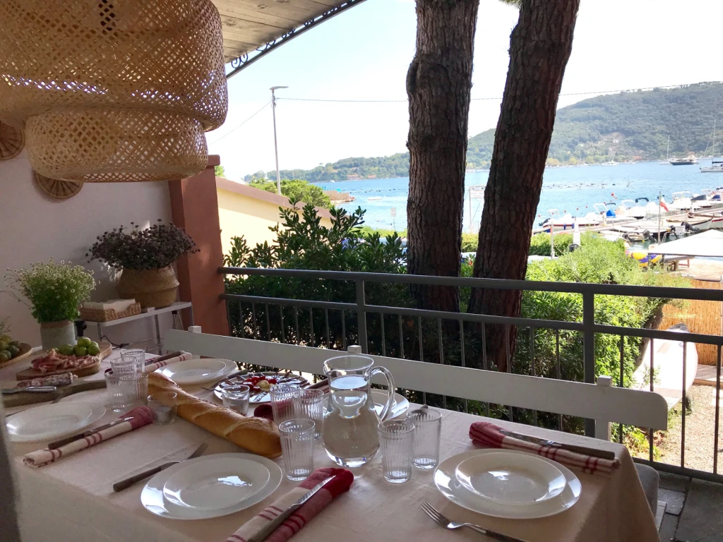 The outdoor terrace is the perfect spot for long lunches, overlooking the bay.