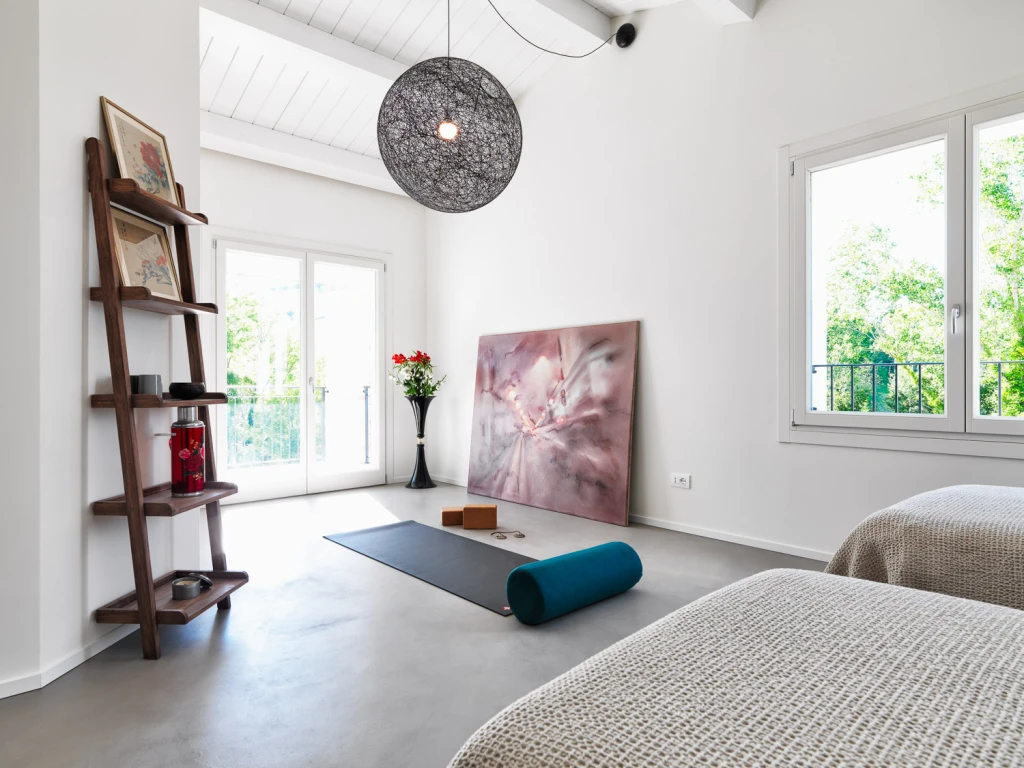A zen bedroom with a space for yoga and meditation