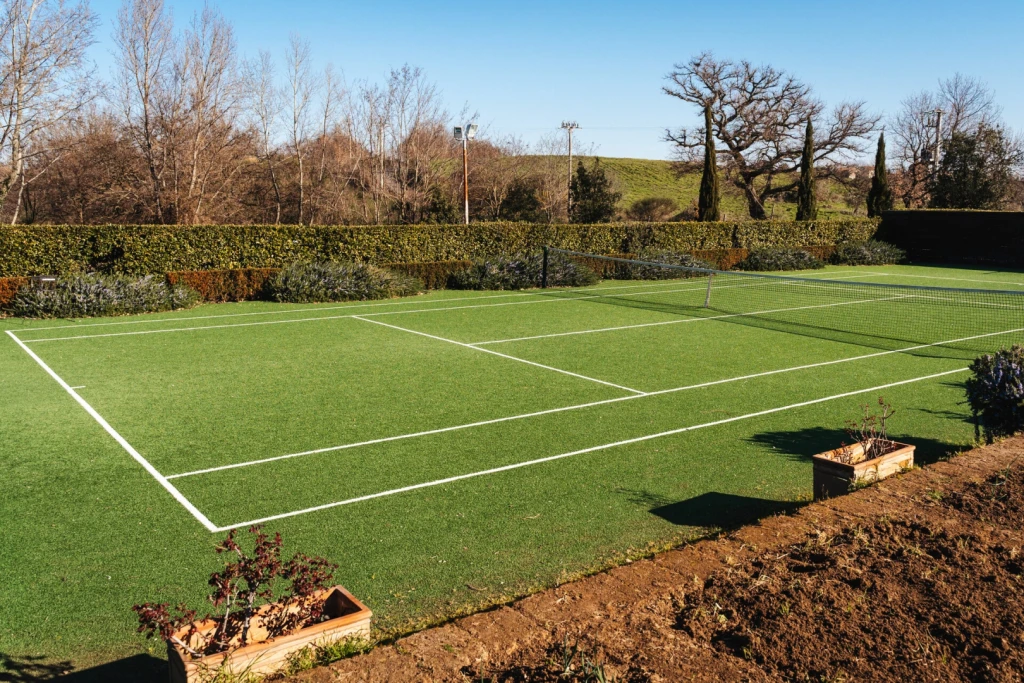 A private grass tennis court in the garden, tennis coach upon request