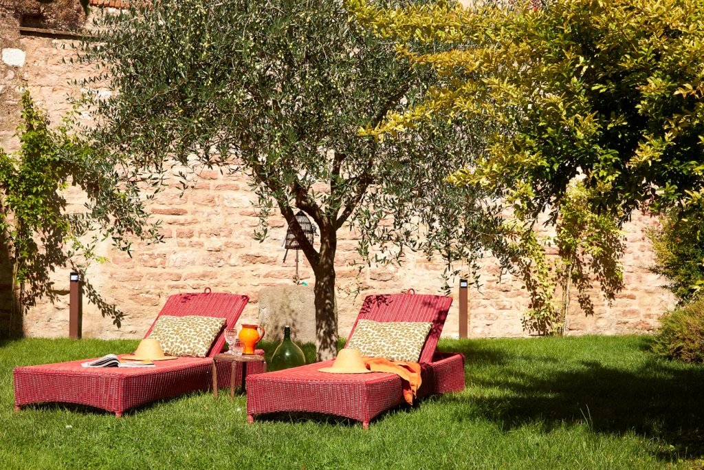 Recline in the shade of a tree or under the pergola on a day bed piled with soft pillows. Enjoy a glass of local wine on the terrace.